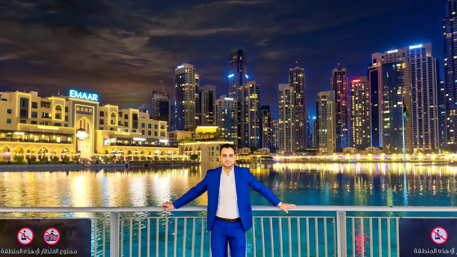 Lithvik Mukesh Sharma stands at a Dubai waterfront at night.
